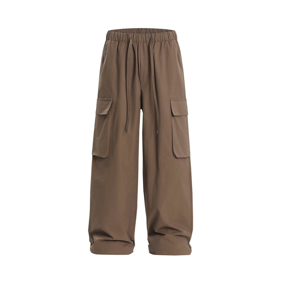 Brown wide-leg cargo pants with elastic drawstring waist and large flap thigh pockets, flat front view