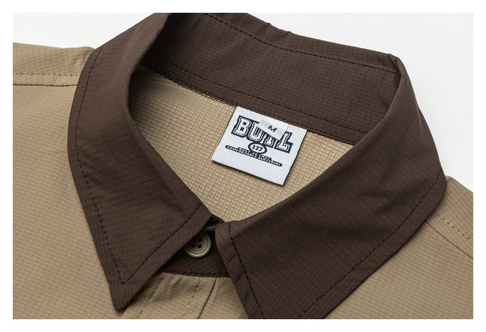 Close-up of a tan shirt's dark brown collar, button, and sewn-in neck label.