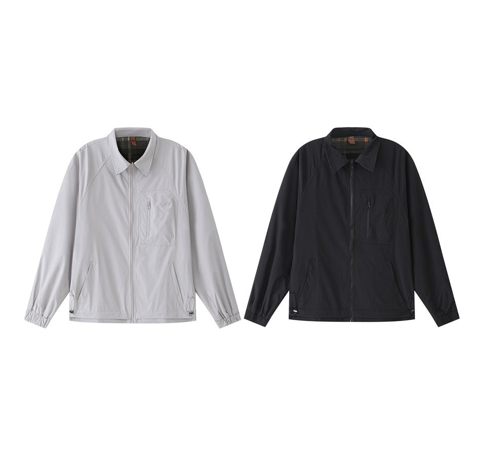 Two zip-front jackets shown from the front: one light gray and one black, each with a pointed collar and chest pocket.