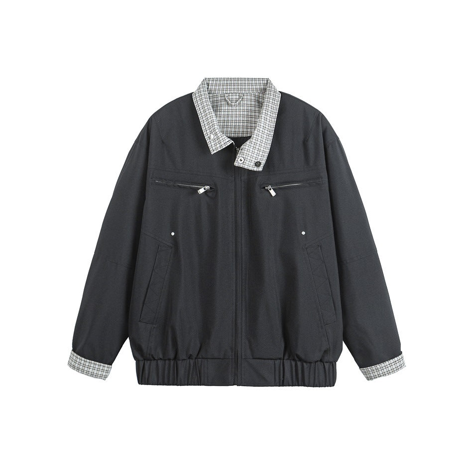 Front view of a black zip-front jacket with checked collar and cuffs, two chest zip pockets, and a gathered hem.