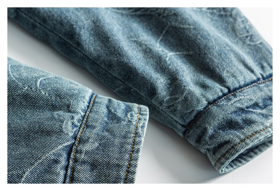 Close-up of blue denim garment edges and stitched cuffs on a white background.