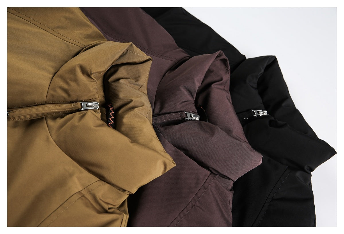 Close-up of black, plum-brown, and tan-brown jackets arranged together, showing their collars and zippers.