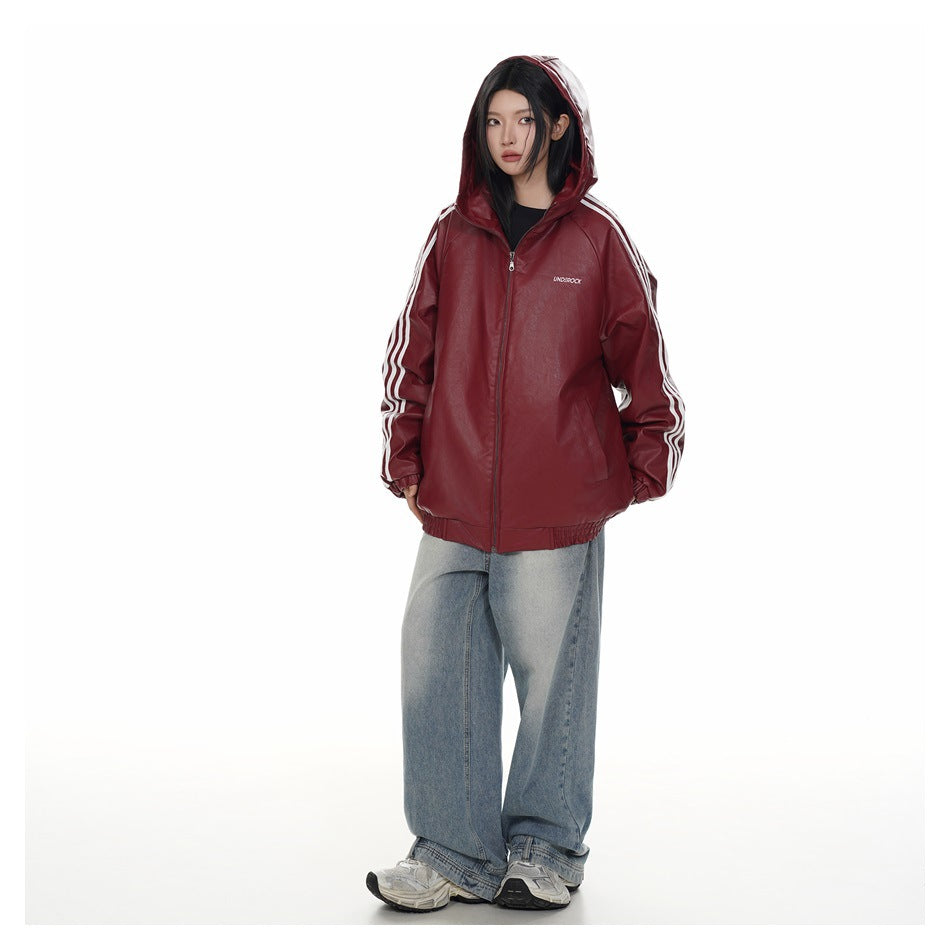 Model wearing a burgundy hooded zip jacket with white sleeve stripes and loose light-wash jeans.