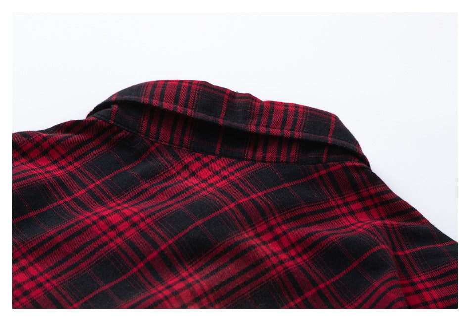 Close-up of the collar and upper section of a red and black plaid garment laid flat.