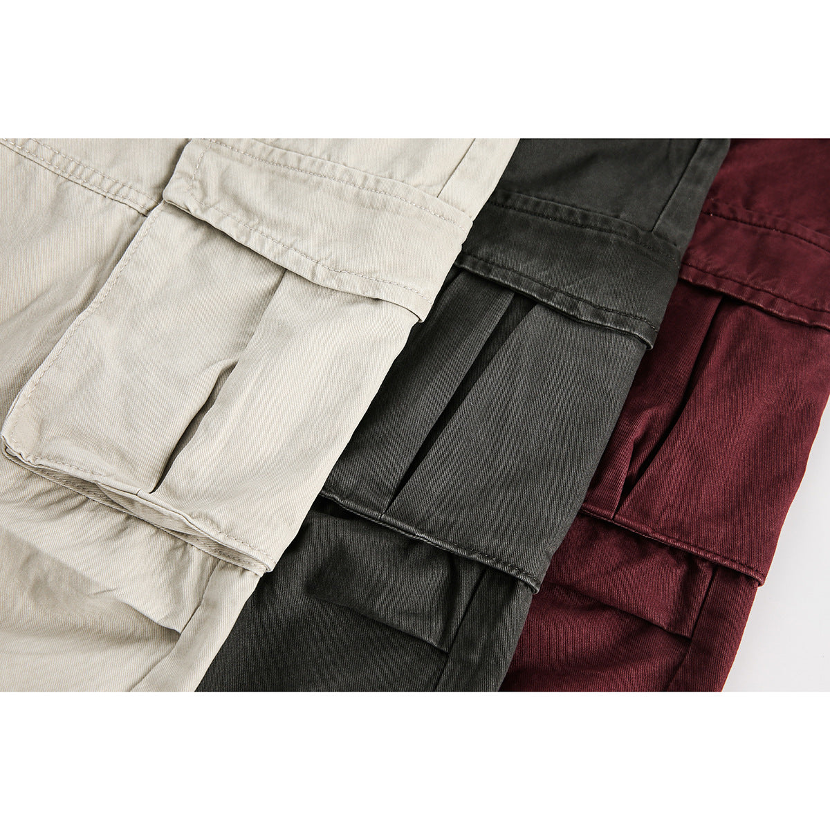 Close-up of cargo pockets on beige, charcoal, and burgundy pants.