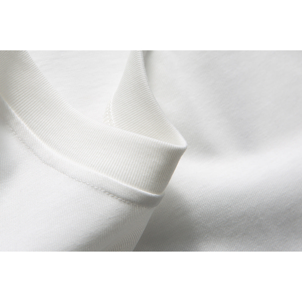 Close-up of the white T-shirt’s ribbed collar and stitching.