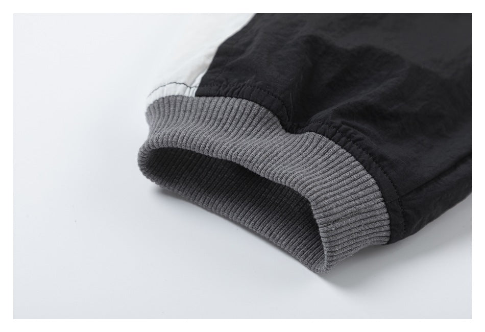 Close-up of a gray ribbed cuff attached to a black sleeve.