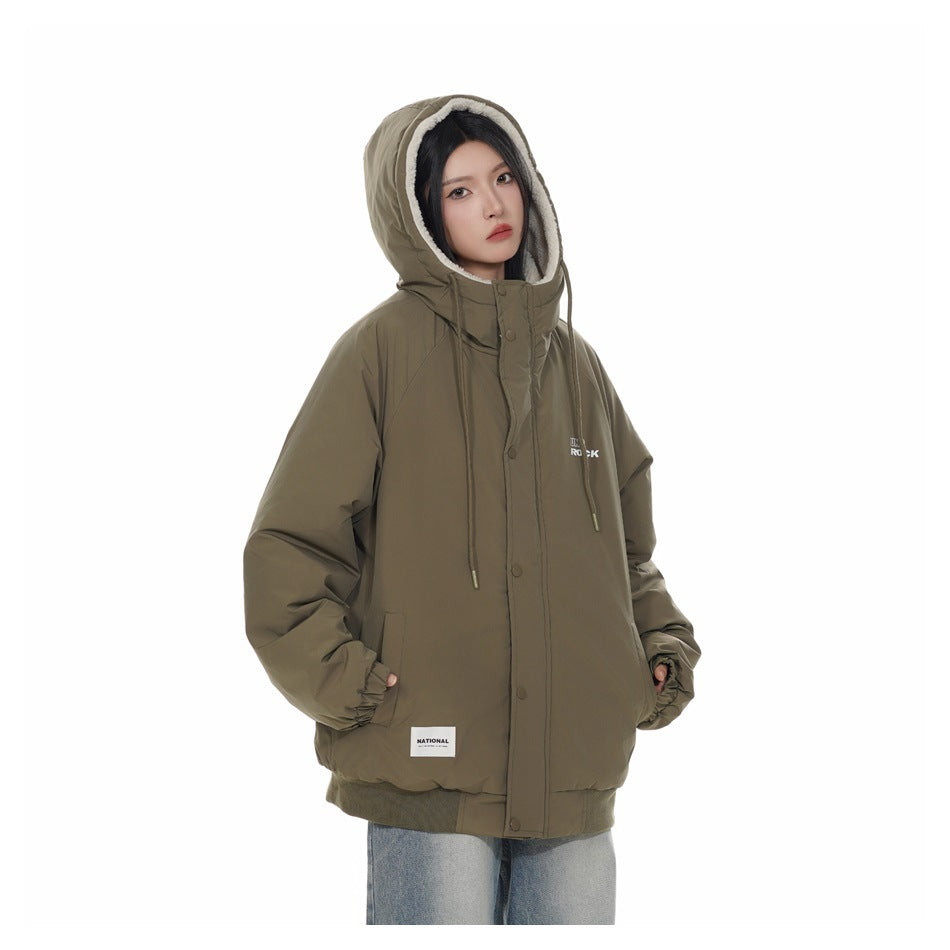 Model wearing an olive green jacket with the hood up, showing cream fleece-like lining and hands in pockets