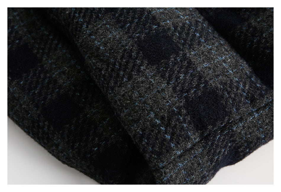 Close-up of dark charcoal fabric with scattered blue flecks and a fuzzy textured surface.
