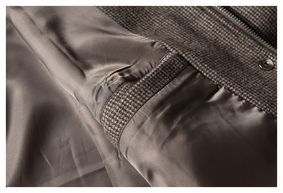 Interior close-up showing smooth brown lining, a houndstooth seam, and the jacket's zipper and snap.