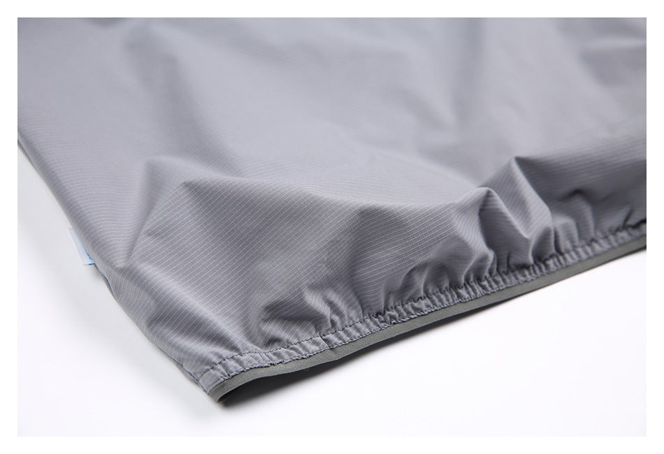 Close-up of a gray, finely striped garment with a gathered, stitched edge.