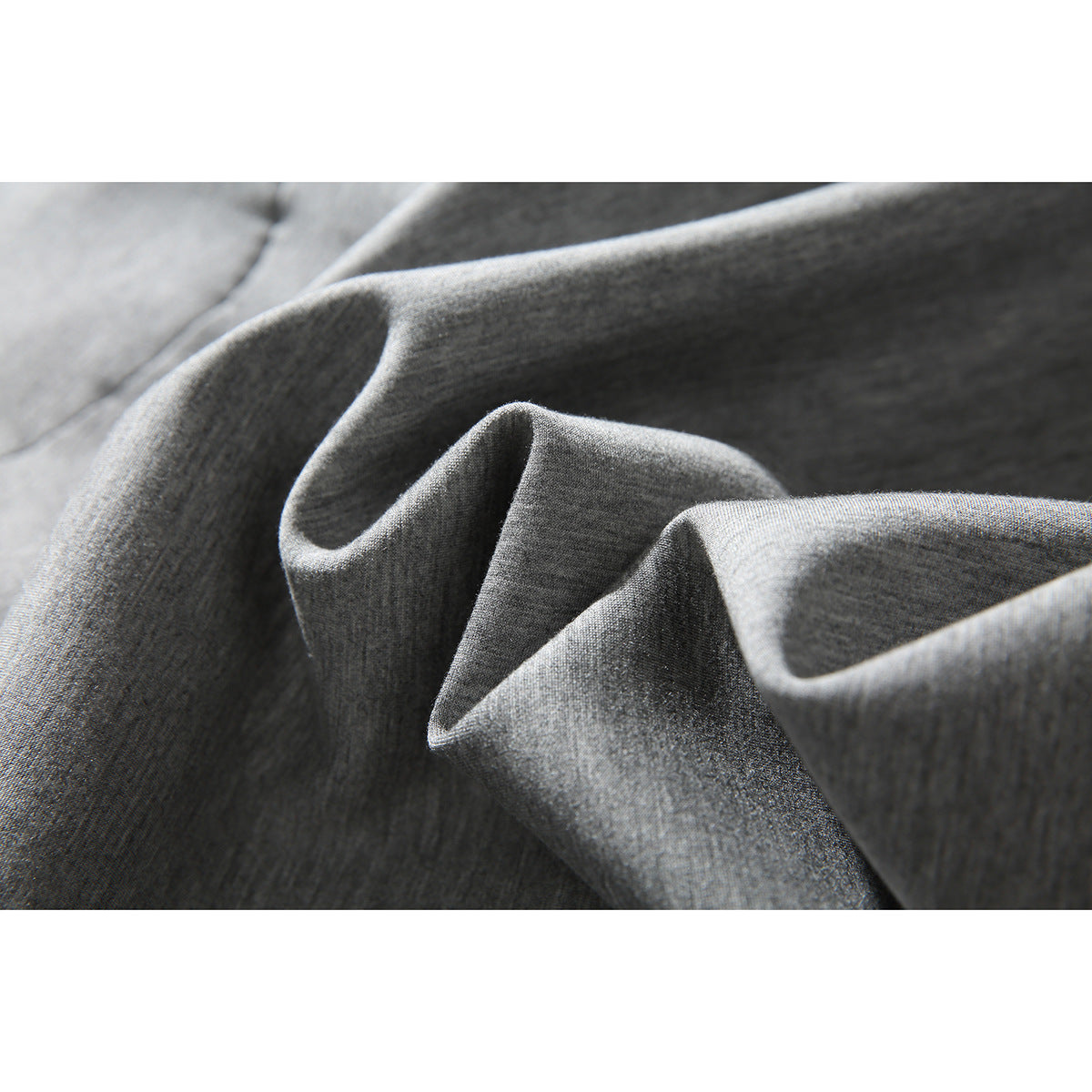 Close-up of the light gray jacket fabric draped into folds.