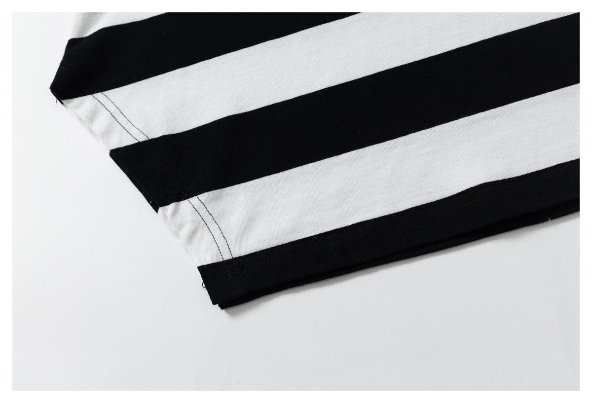 Close-up of the black-and-white striped garment's side seam and stitched hem.