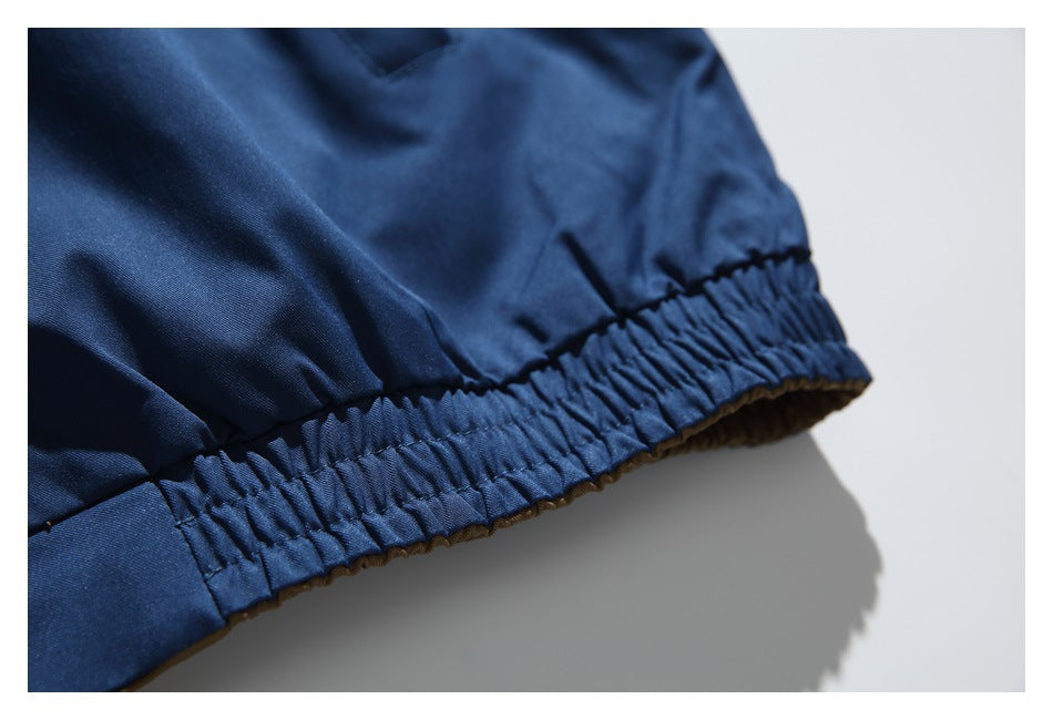 Close-up of the gathered elastic hem on a navy jacket.