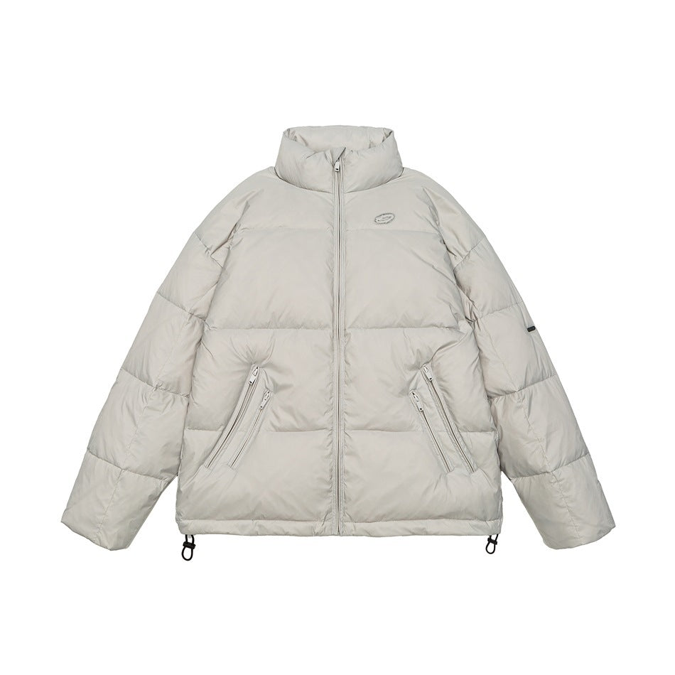 Front view of a light gray puffer jacket with a high collar, full-length zip, two zippered pockets, and hem toggles.