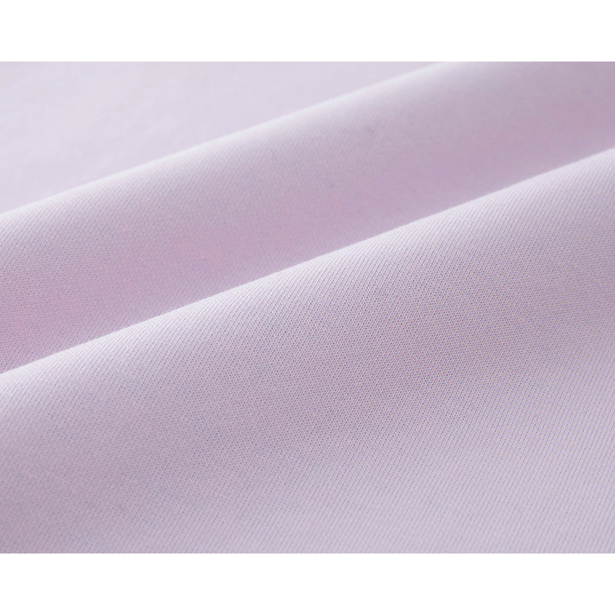 Close-up showing the fine knit texture of pale pink T-shirt fabric.