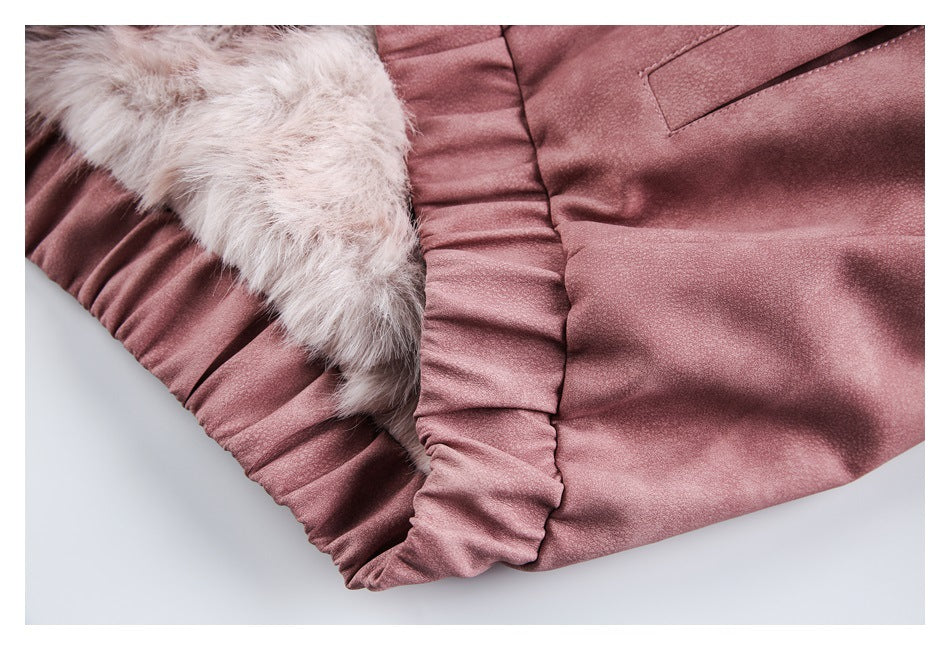 Close-up of the dusty rose jacket's gathered edge beside a pale fluffy lining.