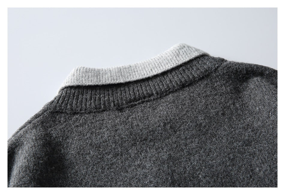 Close-up of the back of a charcoal knit sweater, showing its light gray contrast collar.