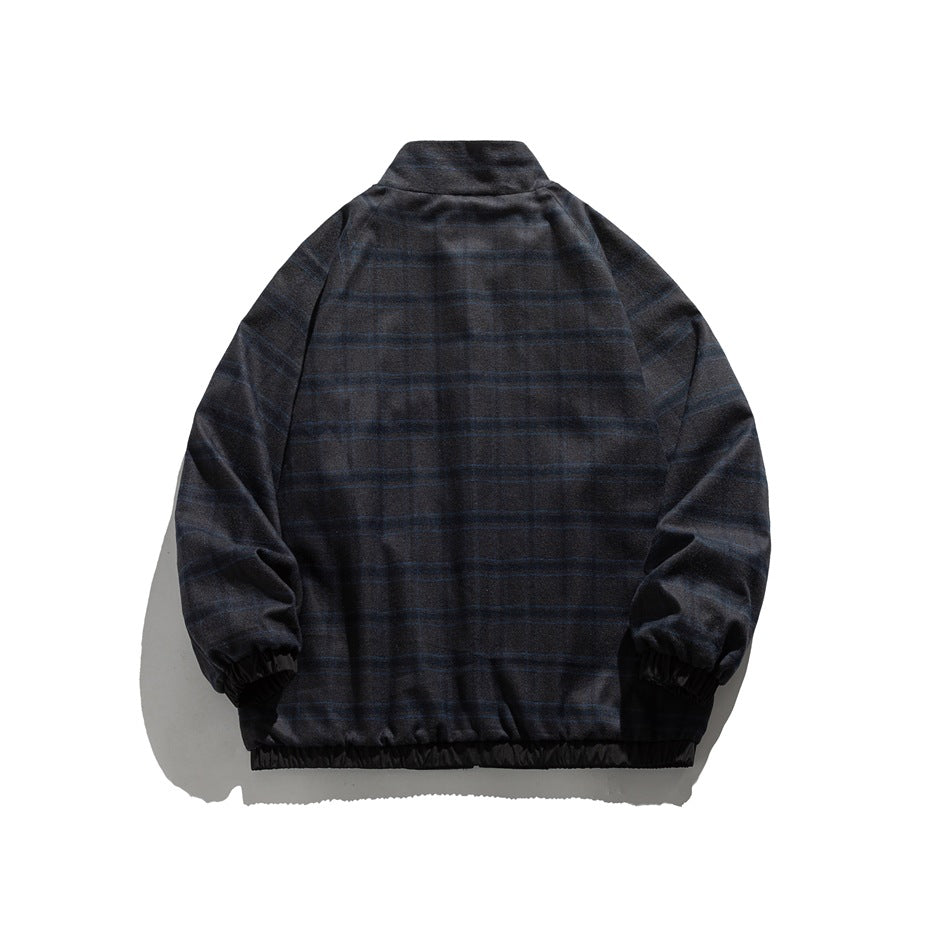 Back view of a dark blue plaid jacket with a stand collar, raglan sleeves, elastic cuffs and hem.