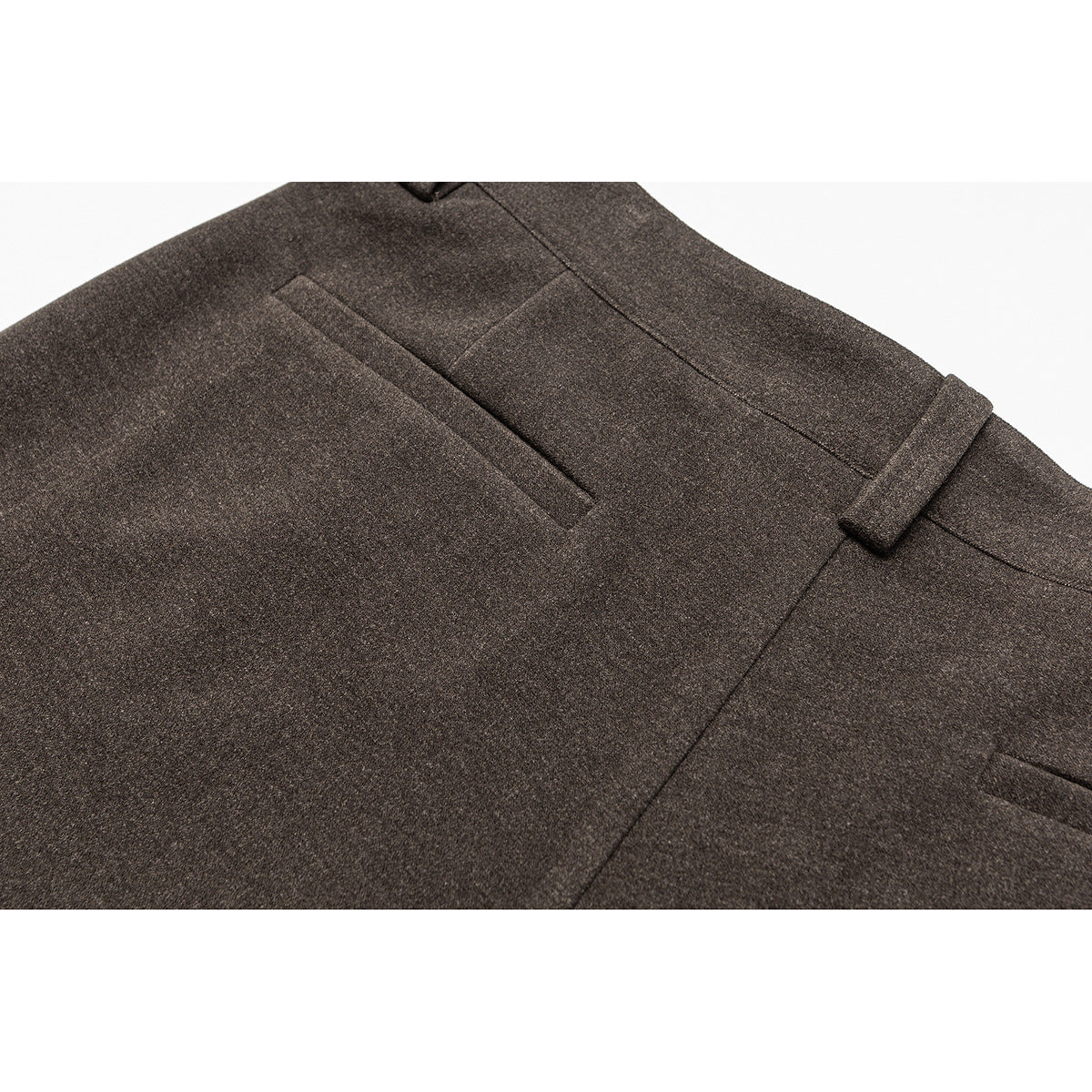 Close-up of brown trousers showing a rear welt pocket, belt loop and seam details.