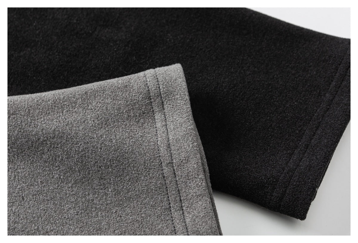 Close-up of gray and black long-sleeve shirt cuffs showing their fabric and stitched edges.