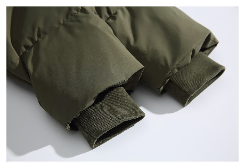 Close-up of olive jacket sleeves with ribbed knit cuffs.
