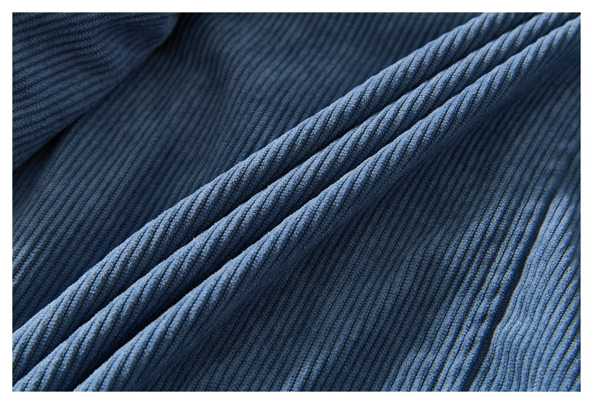Close-up of dark blue ribbed fabric arranged in soft folds.