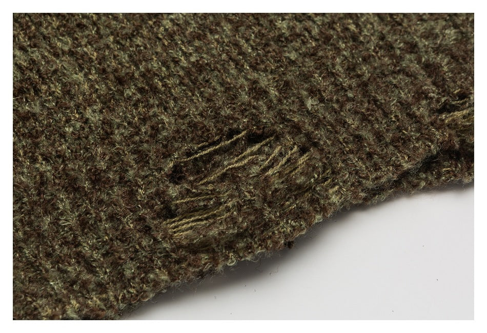 Close-up of brown and olive knit fabric showing a stitched detail beside a curved garment edge.