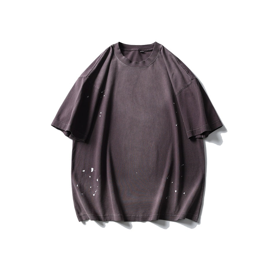 Dark purple washed short-sleeve crew-neck T-shirt with white paint splatter, flat front view