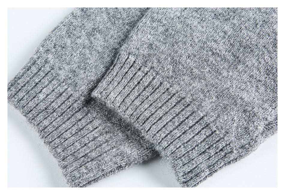 Close-up of two ribbed cuffs on a gray marled knit garment.