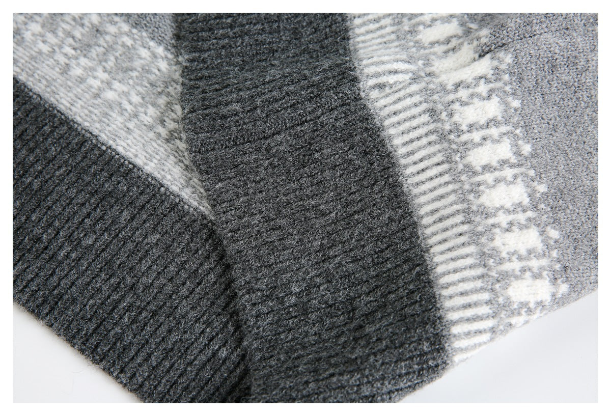 Close-up of overlapping charcoal ribbed knit panels beside a cream geometric stripe on gray knit.