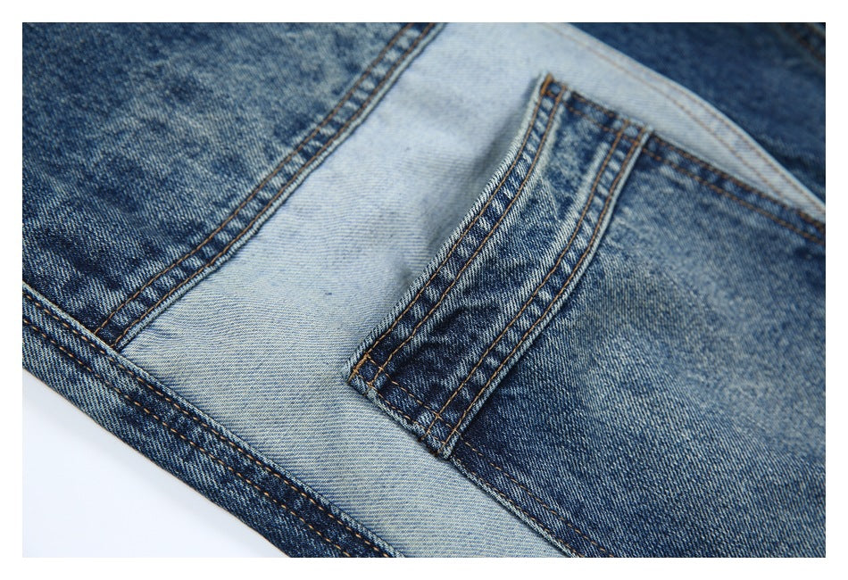 Close-up of a stitched denim pocket and seam against a contrasting light blue panel.