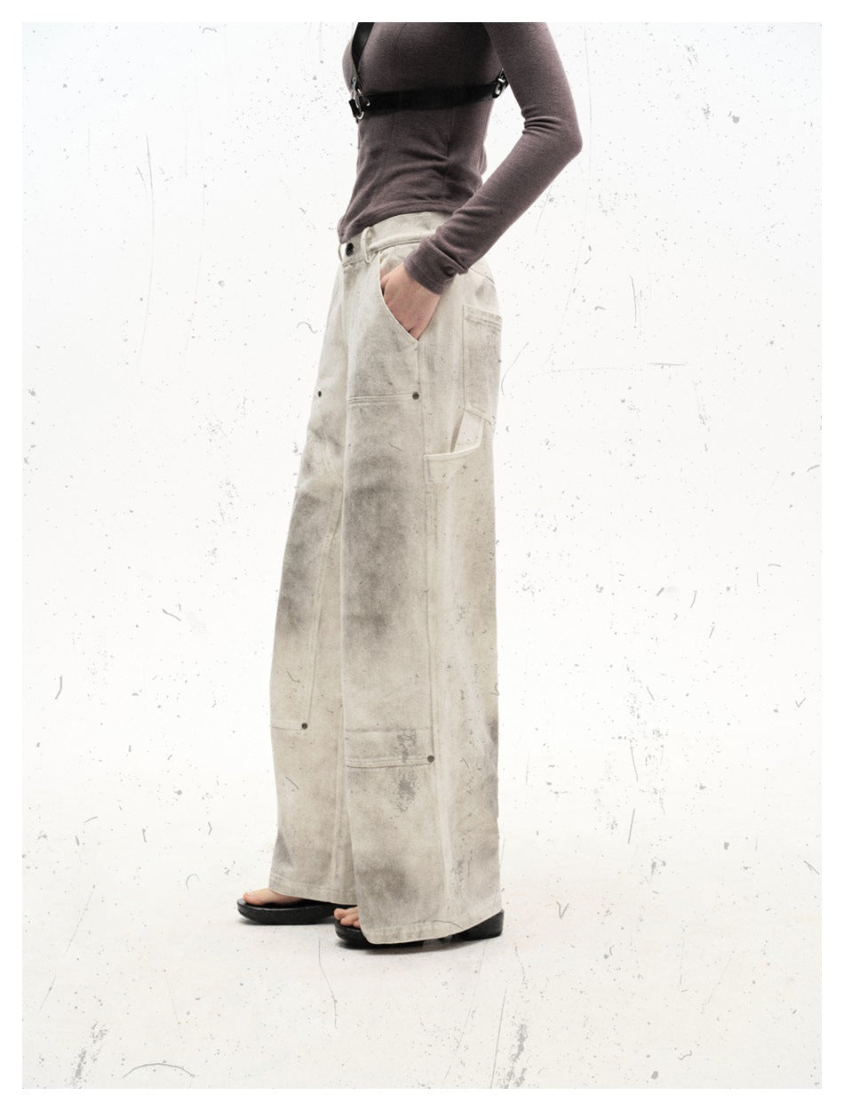 Side view of a model wearing off-white mottled wide-leg utility pants with oversized pockets.