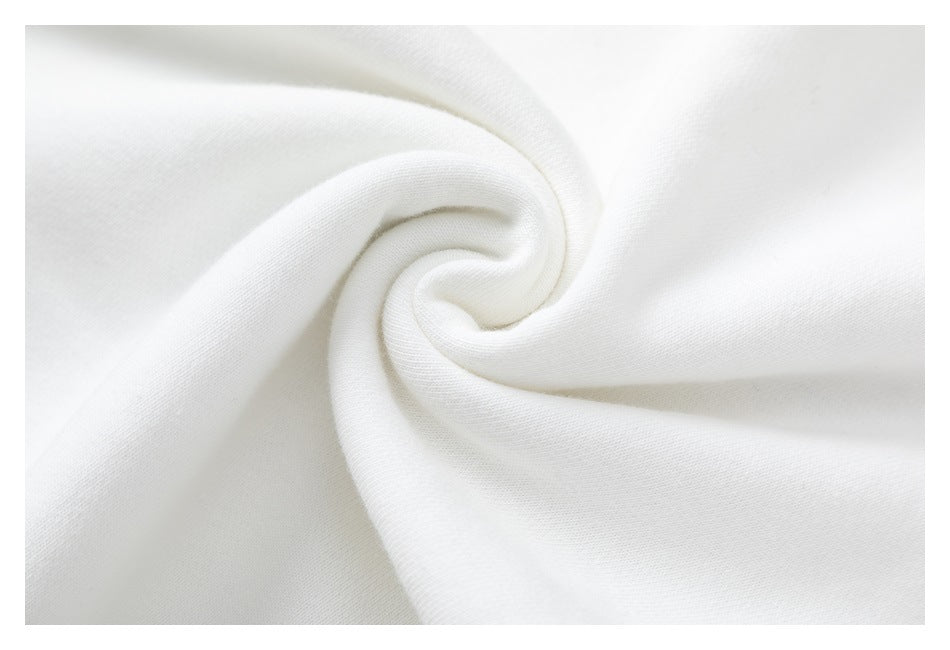 Close-up of the white sweatshirt fabric gathered into a soft spiral fold.