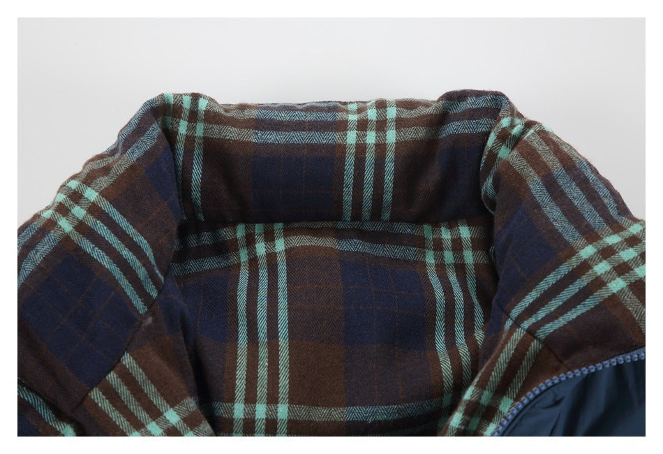 Close-up of the jacket's brown, navy, and teal plaid lining inside the collar.