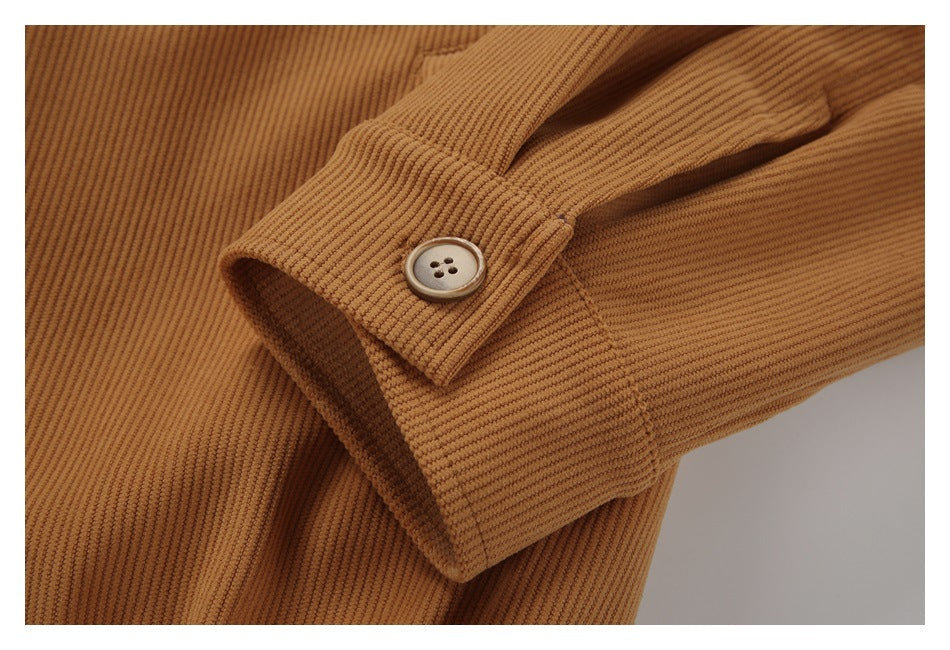 Close-up of a caramel-brown ribbed garment cuff with a round four-hole button.