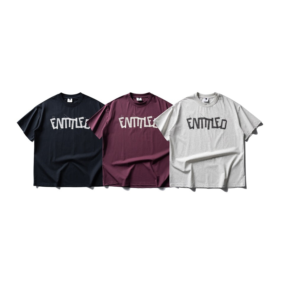 Three short-sleeve crew-neck T-shirts shown from the front in black, burgundy, and light gray, each with graphic lettering.