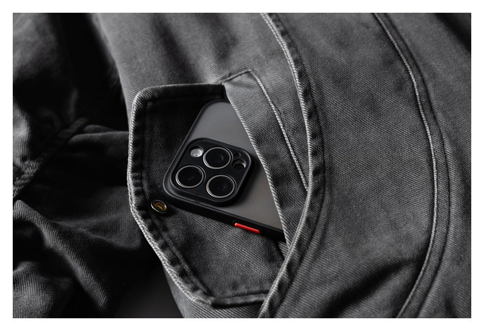 Close-up of a charcoal jacket pocket holding a smartphone, showing the pocket opening and stitching.