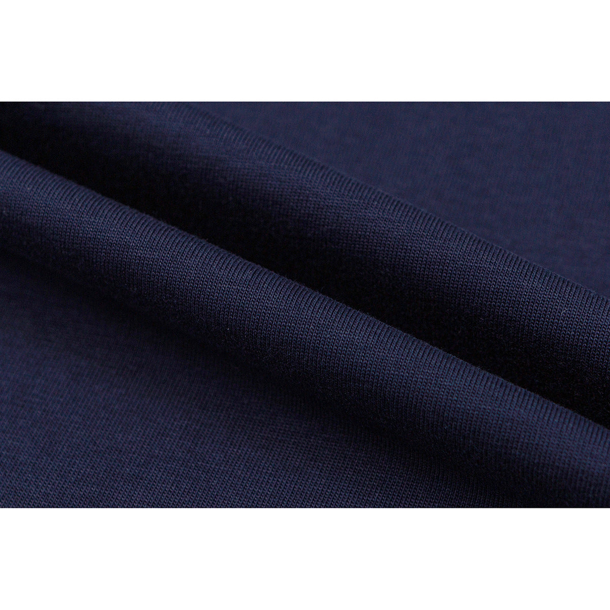 Close-up showing the dark navy knit texture and folds of a T-shirt.