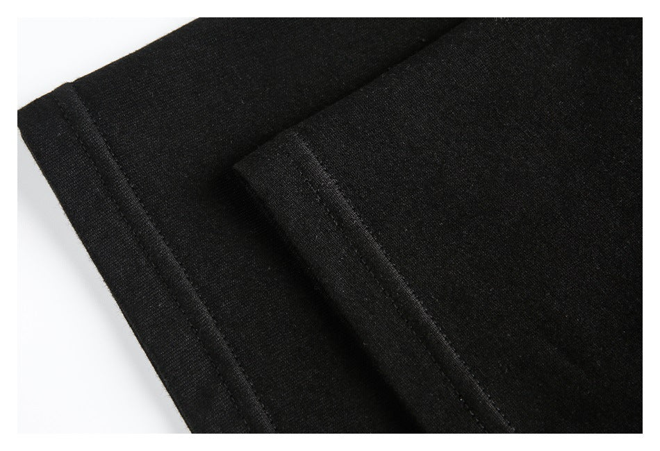 Close-up of black garment fabric with a folded, stitched seam.