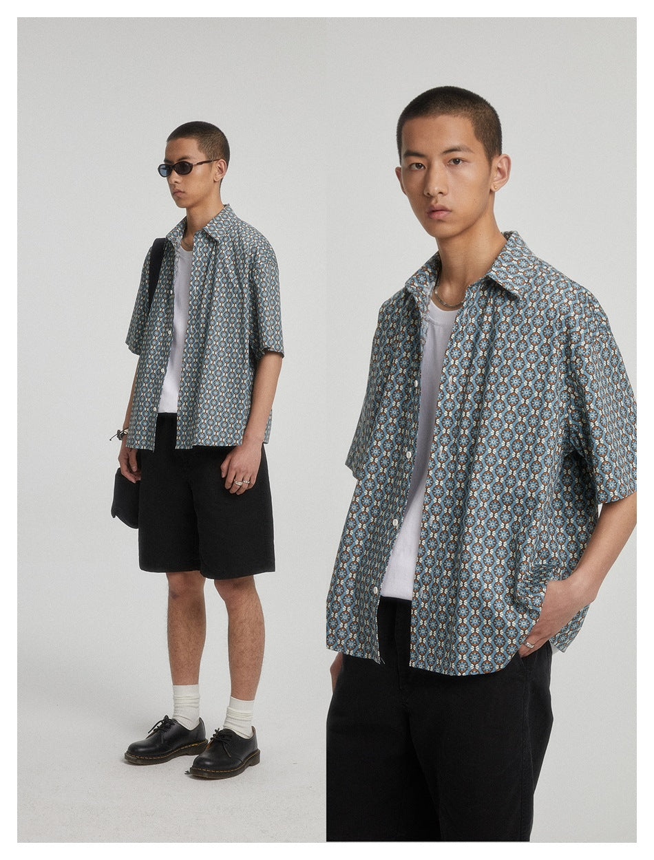 Two-panel view of a model wearing the printed short-sleeve shirt open over a white tank with black shorts and pants