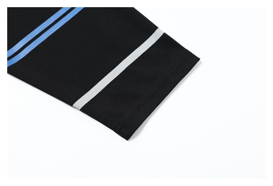 Close-up of a black sleeve hem with blue and white stripes on a white background.