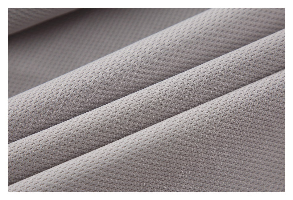 Close-up of pale gray mesh lining with a small repeating perforated pattern.