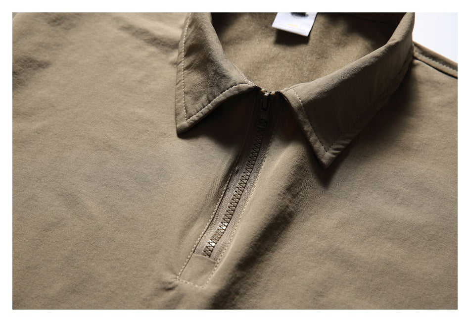 Close-up of the taupe top's pointed collar and short front zipper.