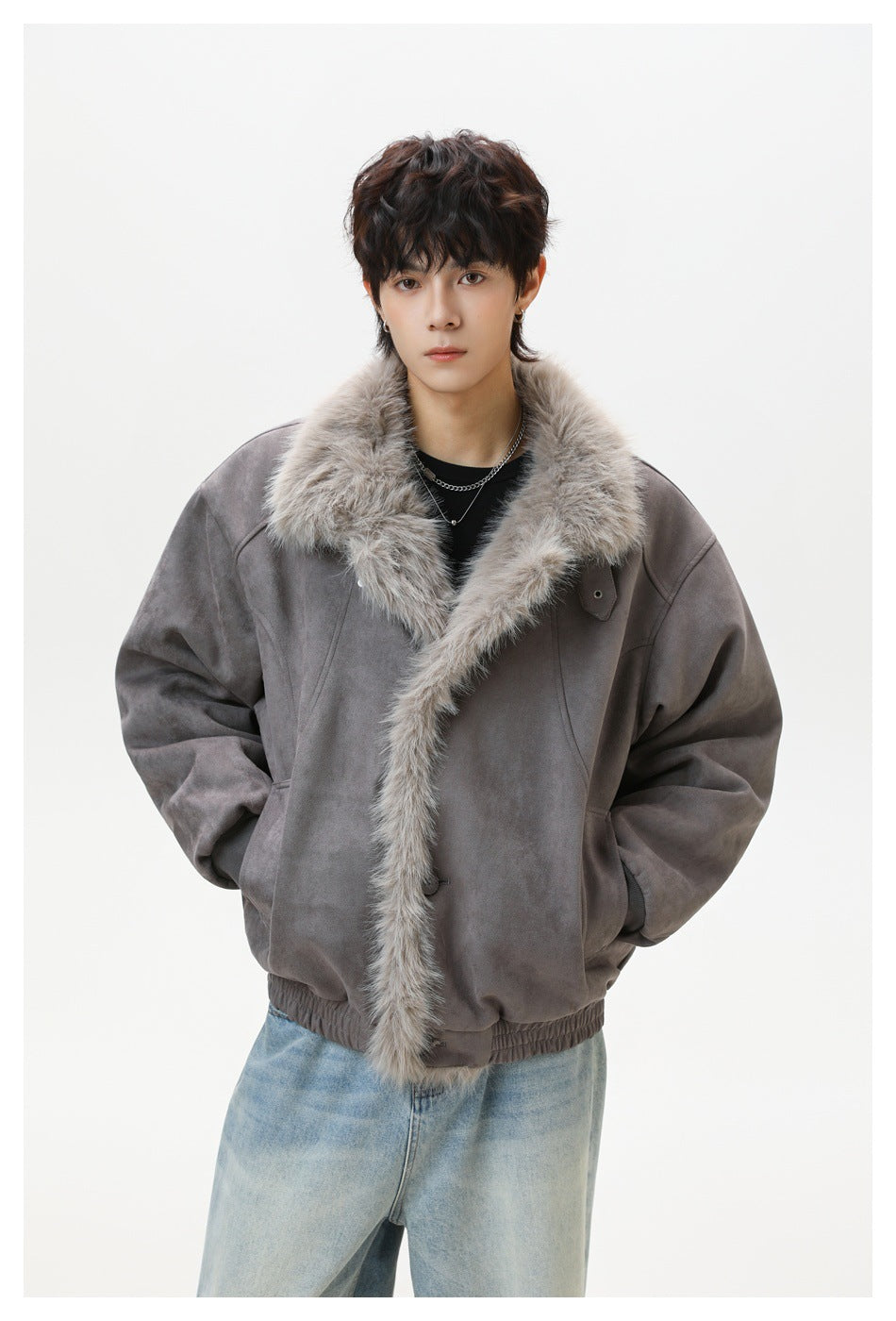 Model wearing a gray suede-look jacket with a fluffy fleece-like collar and front trim, hands in pockets, with light jeans