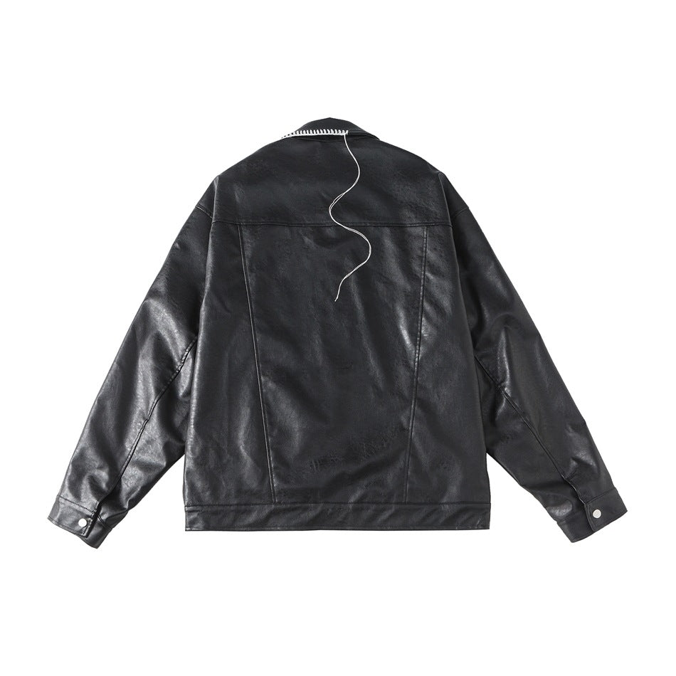 Back view of a black jacket with white contrast stitching at the collar and a loose decorative thread.