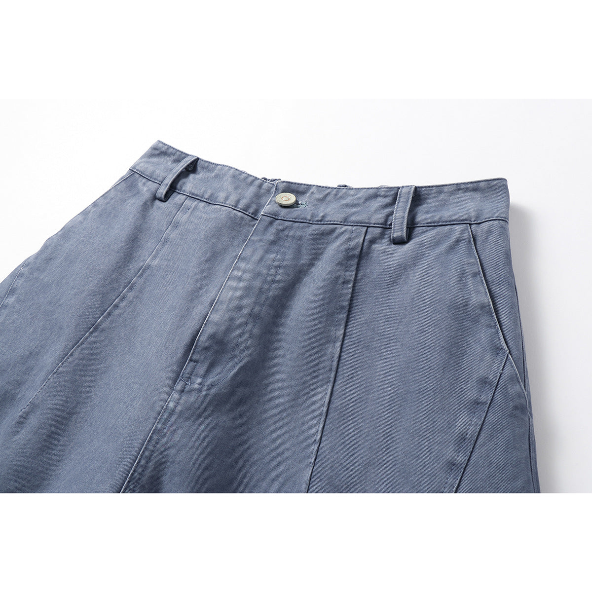 Close-up of blue-gray trousers showing the waistband, button, belt loops, and front seam details.
