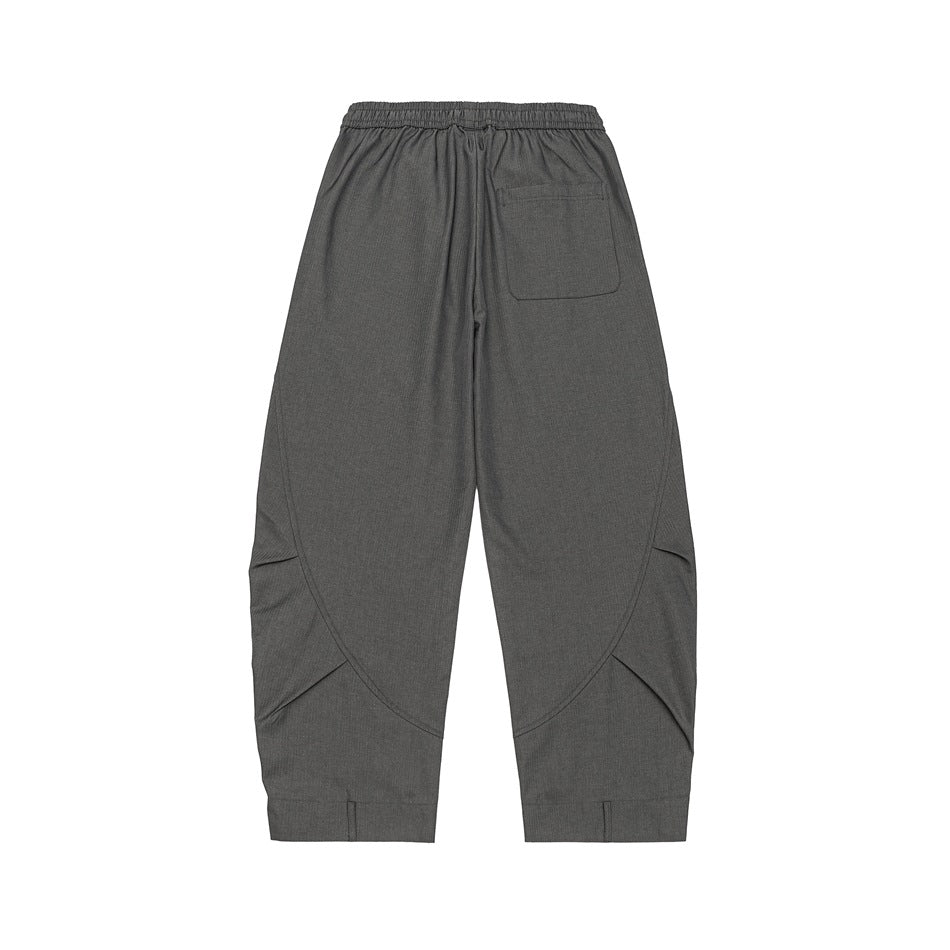 Gray wide-leg pants, back flat lay showing patch pocket, curved seams, elastic waistband and hem tabs