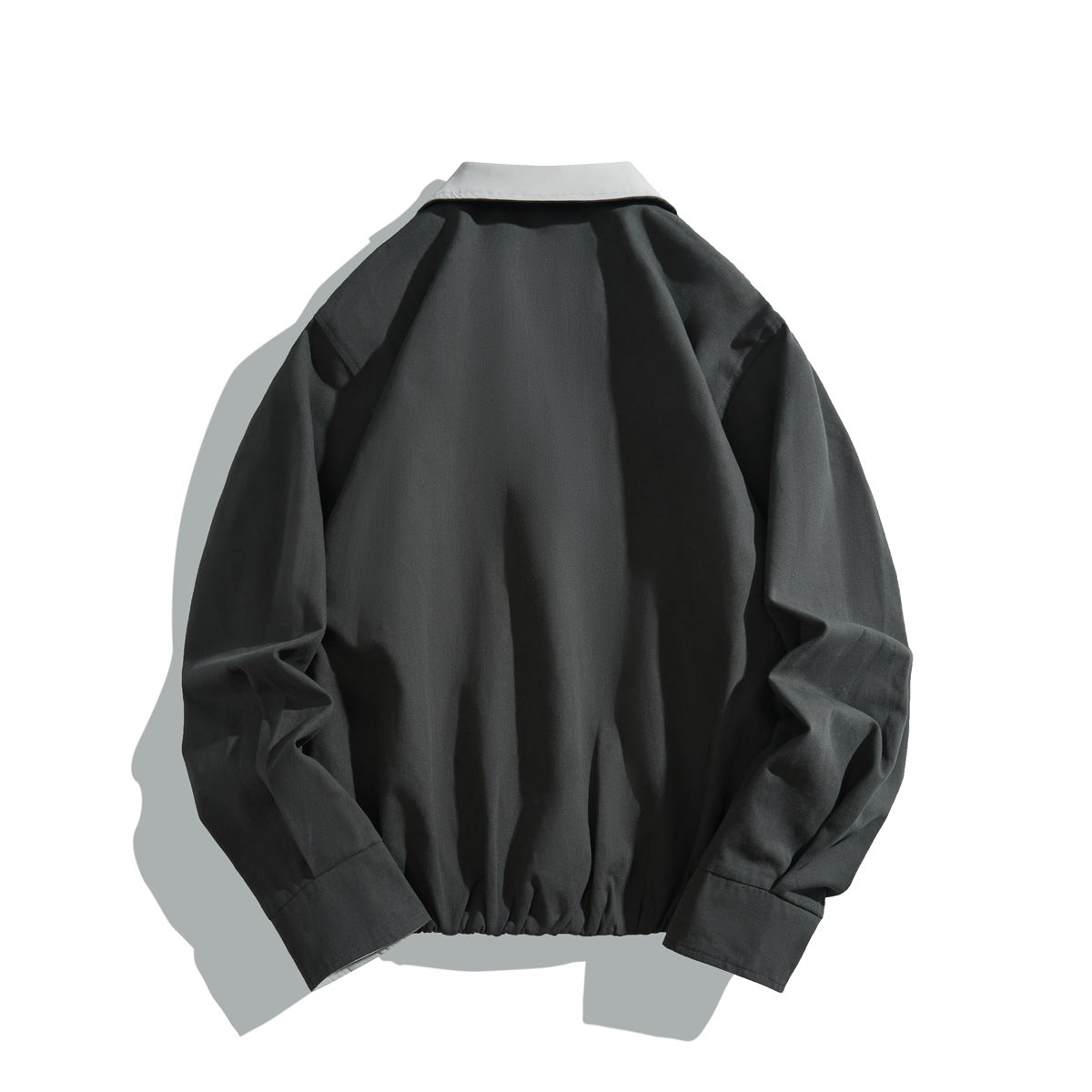 Back view of dark gray jacket with light gray collar, long sleeves and gathered elastic hem, flat lay