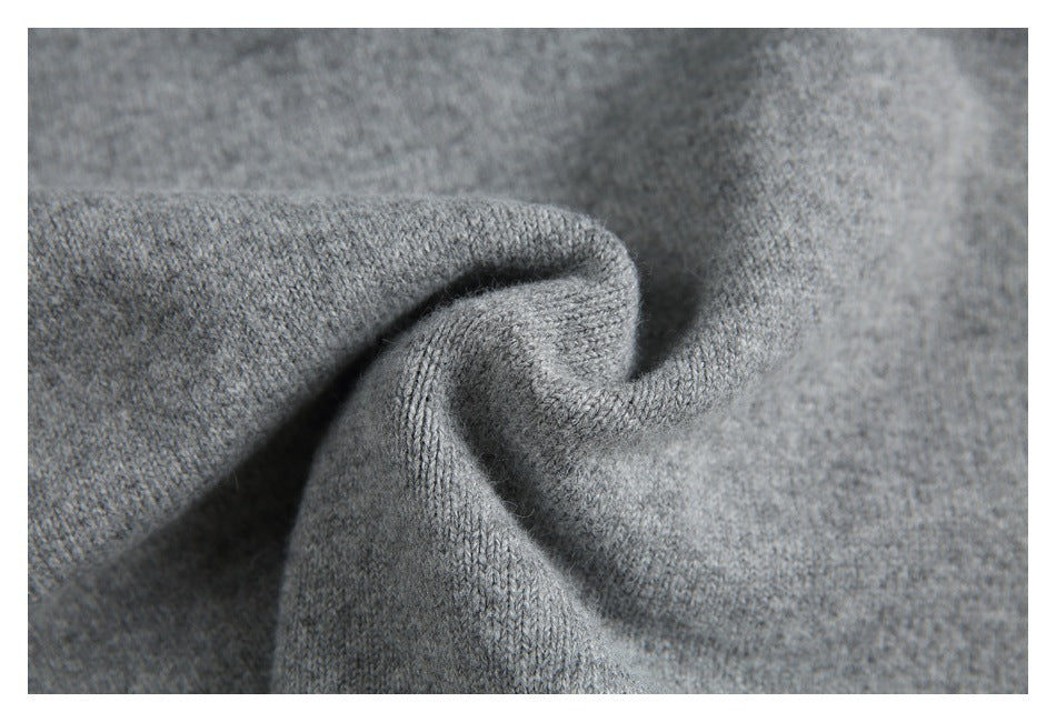 Macro view of heather gray knit stitches, gathered into a soft fold.